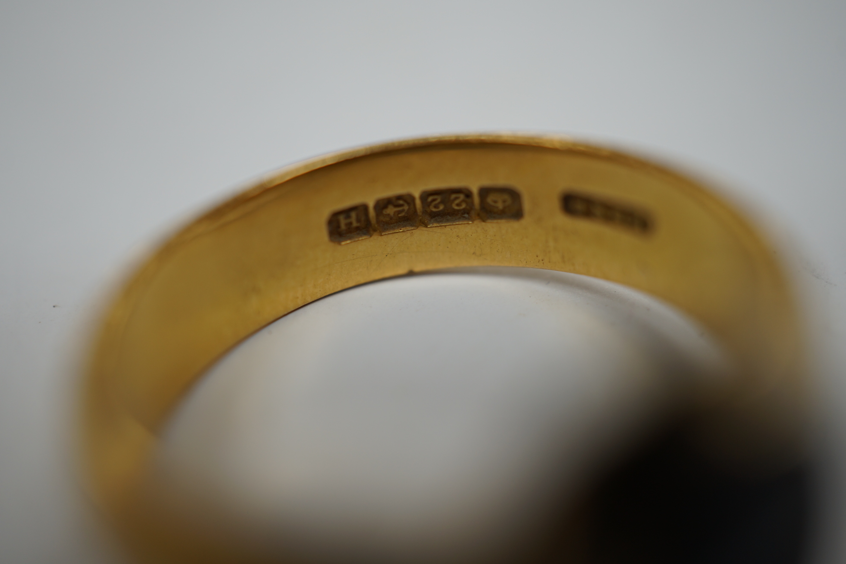 A 1930's part 22ct gold and banded black onyx set signet ring, (the ring head later associated), size Q/R, gross weight 6.8 grams, a pair of engine turned 9ct gold cufflinks, 8.5 grams and one other pair of cufflinks.